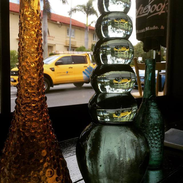Looking through the glass bottles at @papermooncoffeehouse
#glass #refraction #upsidedown #365